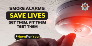 thumb testing a smoke alarm - smoke alarms save lives