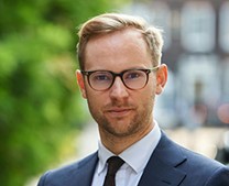 Man with side parting, glasses, shirt and tie